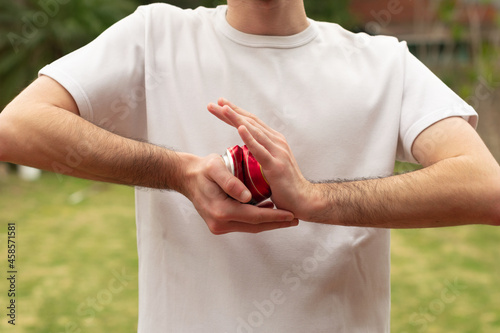 Photography Hands squeezing a can of red beer