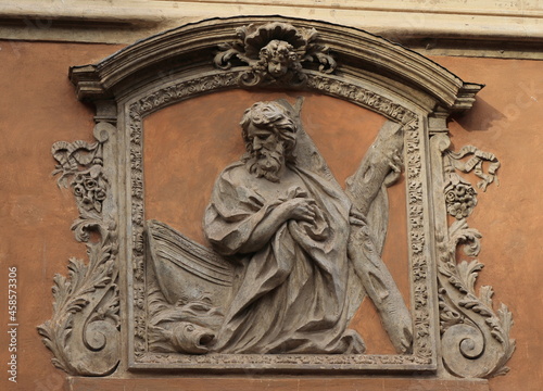 High Relief of Saint Andrew with a Fish and a Boat on the Sant'Andrea dei Pescivendoli Former Church Facade in Rome, Italy photo