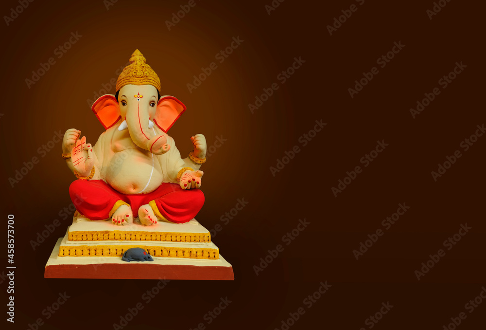 Hindu God Ganesha on colorful background, with copy space, Ganesha is the patron of arts and sciences