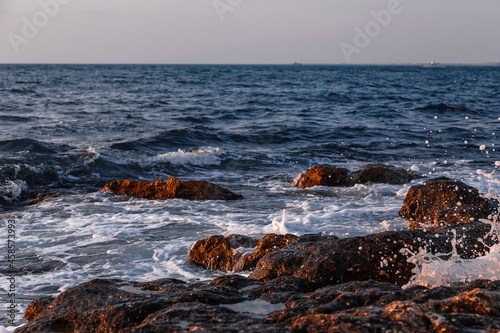 Fototapeta Naklejka Na Ścianę i Meble -  Stones on the seashore. Rocky beach at sunset. Natural background.
