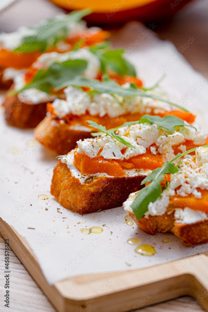 grilled ciabatta bruschetta with baked pumpkin, feta arugula and spices. healthy fall baked pumpkin snack grilled ciabatta bruschetta with baked pumpkin, feta arugula and spices. healthy fall baked pumpkin snack
