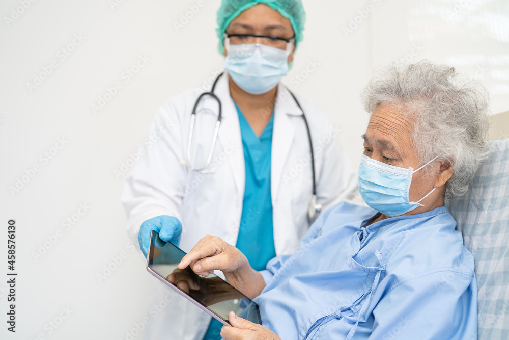 Doctor help Asian senior or elderly old lady woman patient wearing a face mask in hospital for protect safety infection and kill Covid-19 Coronavirus. Doctor help Asian senior or elderly old lady woman patient wearing a face mask in hospital for protect safety infection and kill Covid-19 Coronavirus.