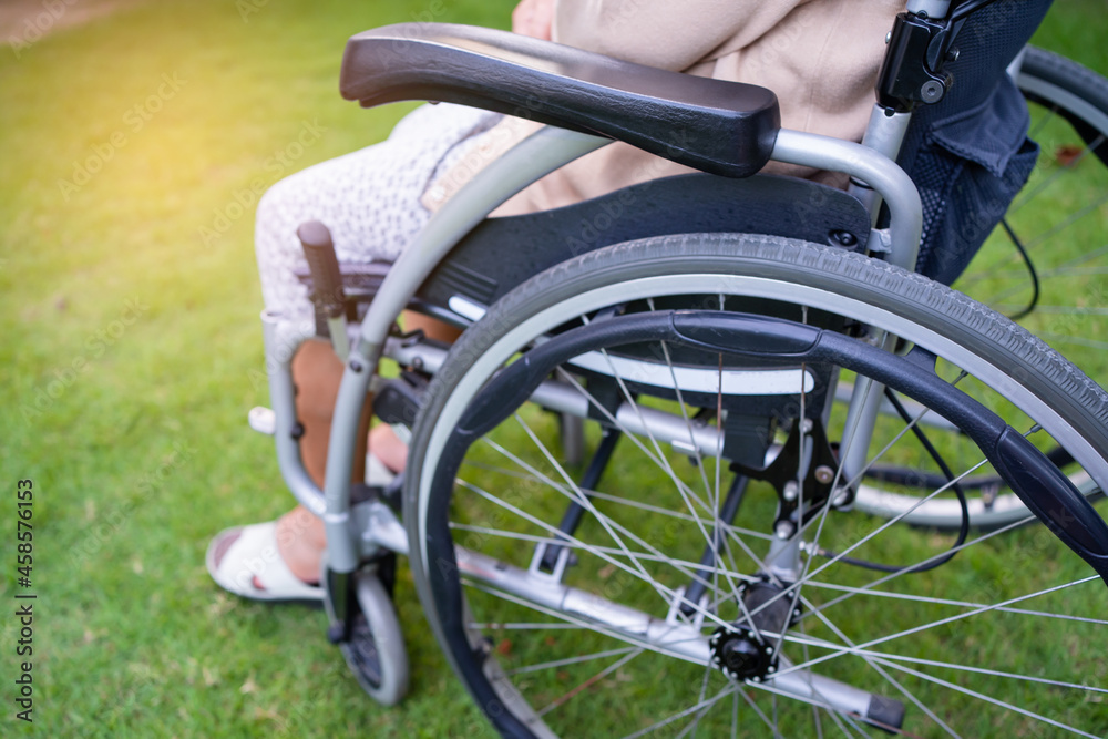 Asian senior or elderly old lady woman patient on wheelchair in park, healthy strong medical concept. Asian senior or elderly old lady woman patient on wheelchair in park, healthy strong medical concept.