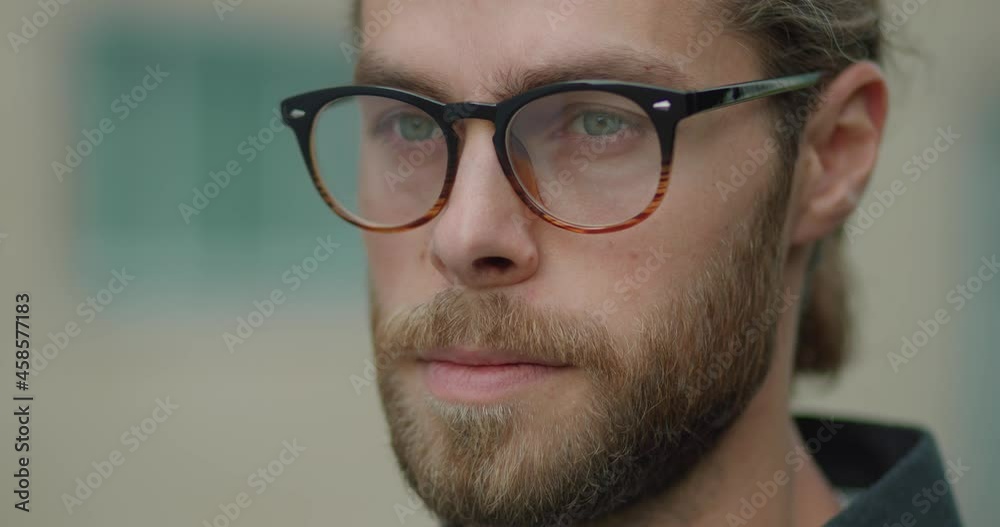 Portrait Face of Serious Caucasian Businessman in Eyeglasses looking ahead. Professional Young Man Entrepreneur standing outdoors. Looking Thoughtfully. Having an Attractive Face. Smart Male. Portrait Face of Serious Caucasian Businessman in Eyeglasses looking ahead. Professional Young Man Entrepreneur standing outdoors. Looking Thoughtfully. Having an Attractive Face. Smart Male.