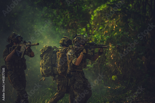  soldier with a rifle.Army soldier in protective uniform holding rifle .special forces soldier assault rifle with silencer. Sniper in the forest. 