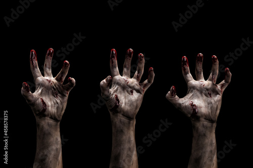 Set of dirty creepy bloody zombies hands with different posing. Horror and Halloween theme. Isolated on black. © raland