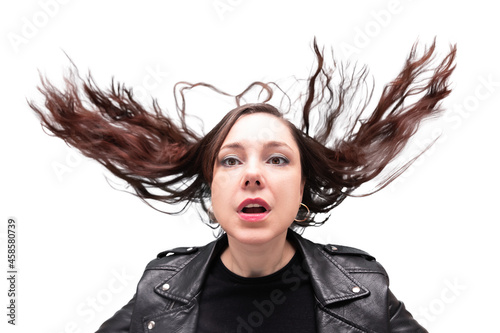 Portrait of woman in black biker jacket with tossed up hair and open mouth, heavy metal style, isolated on white background