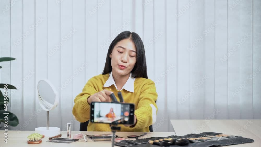Asian Female beauty blogger Influencer filming cosmetics makeup or comparing review on live stream.
Asian Female beauty blogger Influencer filming cosmetics makeup or comparing review on live stream.