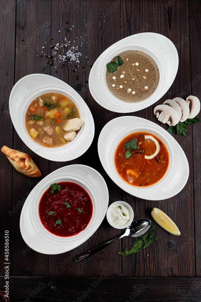 Assortment of soups in a restaurant menu: mushroom cream soup, peasants' soup, borsch and chicken soup Assortment of soups in a restaurant menu: mushroom cream soup, peasants' soup, borsch and chicken soup