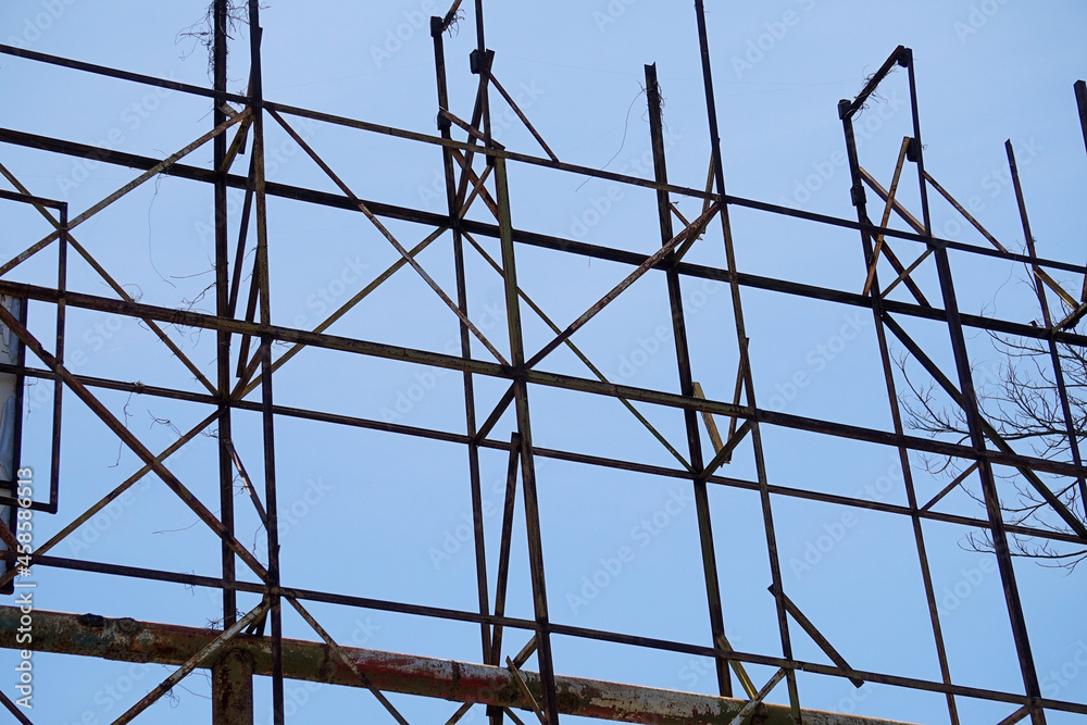 abandoned construction that has been weathered and rusty. an old steel pole structure that could be dangerous. abandoned construction that has been weathered and rusty. an old steel pole structure that could be dangerous.