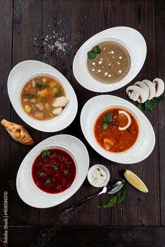 Assortment of soups in a restaurant menu: mushroom cream soup, peasants' soup, borsch and chicken soup