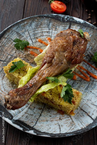 Roasted chicken drumstick with golden fried rice as a dinner in a fancy restaurant