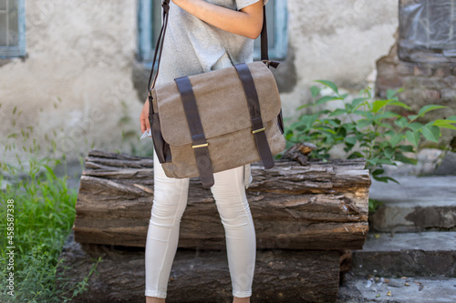 Woman with a gray canvas messenger bag photo