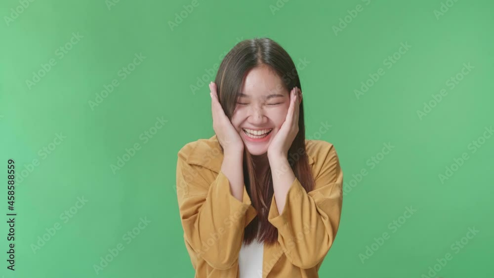 The Surprised Asian Woman Positively Shaking Her Head And Pressing Her Hands To Her Face To The Camera In Green Screen Studio
The Surprised Asian Woman Positively Shaking Her Head And Pressing Her Hands To Her Face To The Camera In Green Screen Studio
