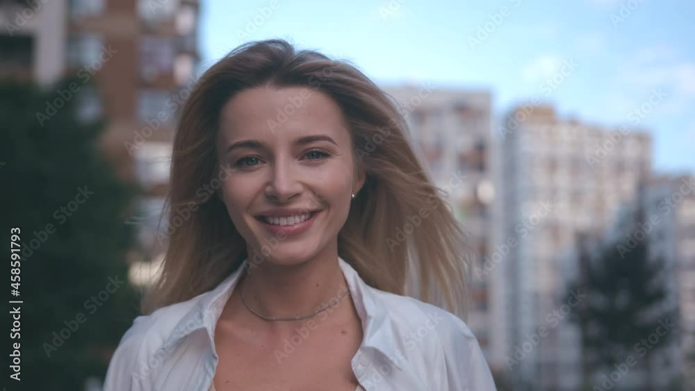 The beautiful smiling woman walking on the street. slow motion The beautiful smiling woman walking on the street. slow motion