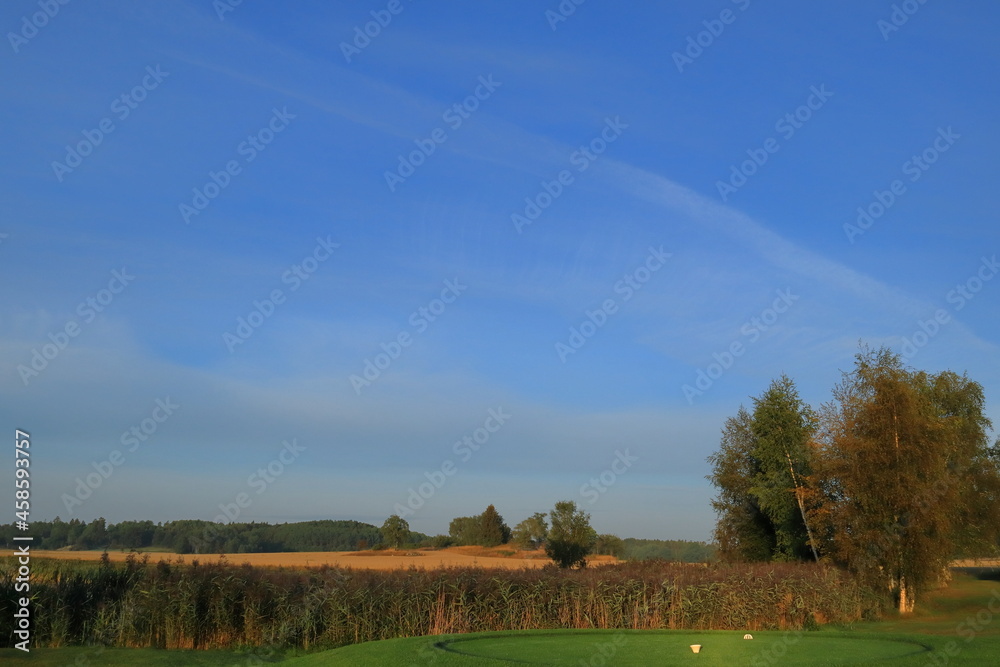 Partly golf course and farm land. Swedish countryside. Nice summer photo with sunlight in the air. Vallentuna, Stockholm, Sweden, Scandinavia, Europe.