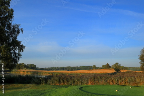 Partly golf course and farm land. Swedish countryside. Nice summer photo with sunlight in the air. Vallentuna, Stockholm, Sweden, Scandinavia, Europe. photo