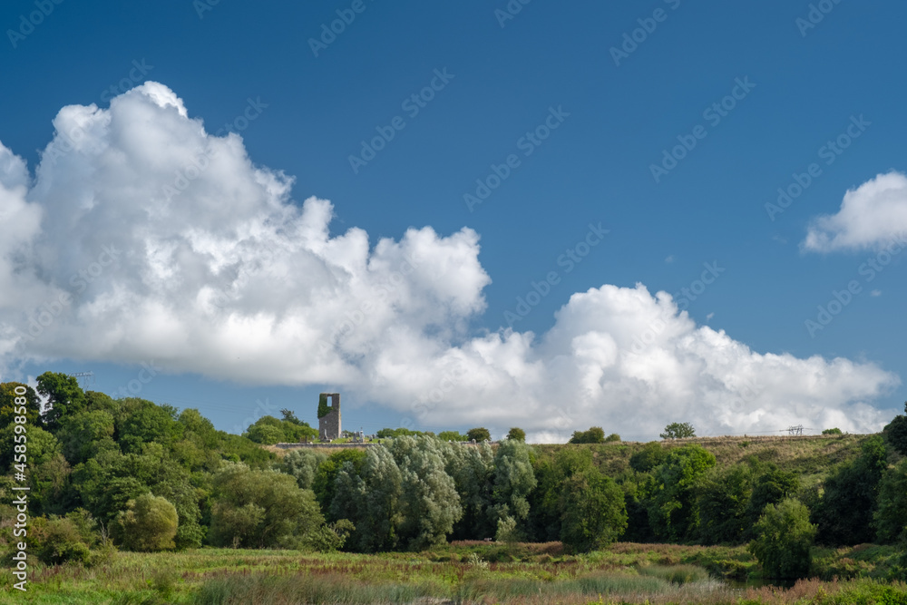 Church ruins on the hill with trees in the foreground and clouds in the background. Navan, Co. Meath, Ireland. September 19, 2021 Church ruins on the hill with trees in the foreground and clouds in the background. Navan, Co. Meath, Ireland. September 19, 2021