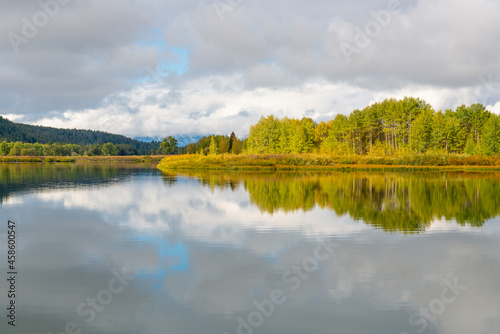 Autumn tree colors reflection by Oxbow Bend and Snake river, Grand Teton national park, Wyoming, USA.