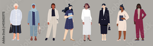 Set of female business characters in various office clothes on grey background. Diverse standing women in office outfits. Flat cartoon vector illustration