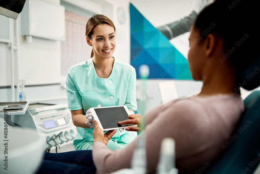Happy dental nurse and female patients using digital tablet at dental clinic. Happy dental nurse and female patients using digital tablet at dental clinic.