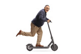 Funny mature man riding an electric scooter and looking at camera