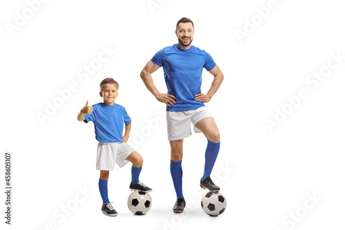 Football coach and a boy with a soccer ball gesturing thumbs up