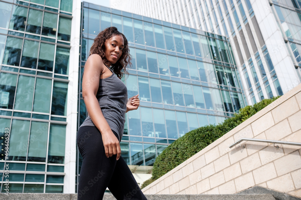 Fitness mature black woman posing in a business environment.