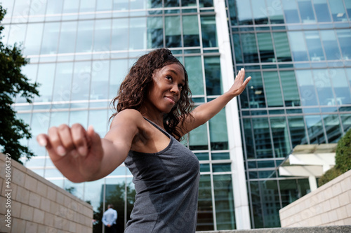 Happy fitness mature black woman stretching.