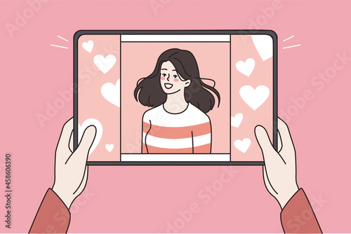 Online dating and technologies concept. Human hands holding tablet with smiling pretty girl on screen feeling love vector illustration 
