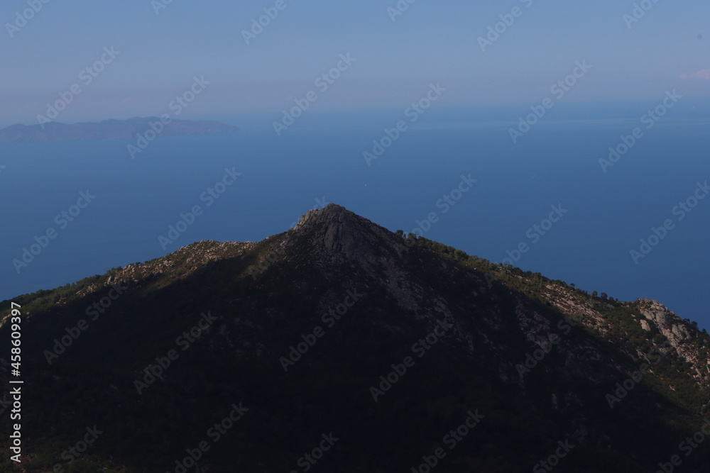 Fototapeta premium Elba, Italy – September 01, 2021: beautiful places from Elba Island. Aerial view to the island. Little famous villages near the beaches. Summer tourist places. Clouds and blue sky in the background.