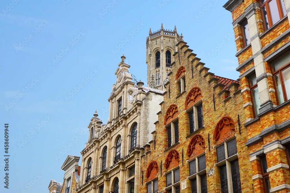Bruges historic gable along the Steenstraat and the famous belfry bell tower as a symbol of the city, Belgium