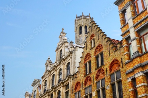 Bruges historic gable along the Steenstraat and the famous belfry bell tower as a symbol of the city, Belgium
