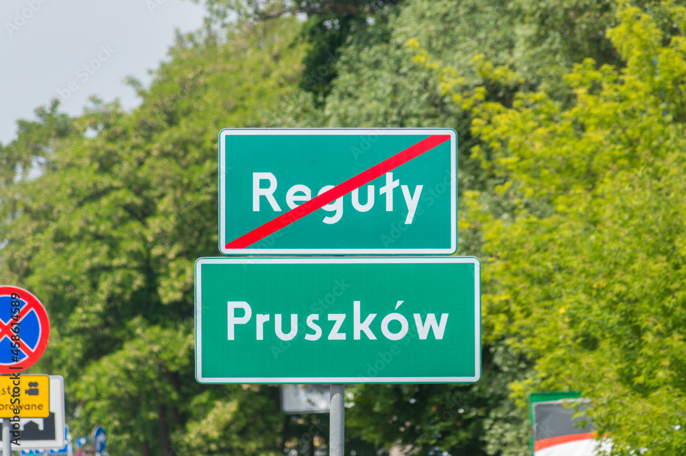 Entrance street sign to Pruszkow city and street sign of the end of Reguly village.