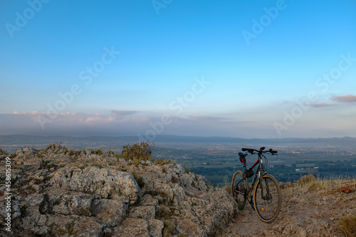 Mountain bicycle on top of a rock mountain peak scenic landscape view