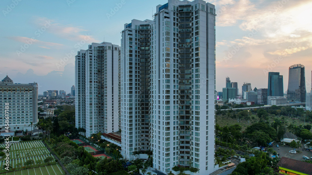 Aerial view of Asia Business concept for real estate - panoramic modern cityscape building bird eye aerial view under sunset and blue bright sky in Jakarta. Jakarta, Indonesia, September 23, 2021