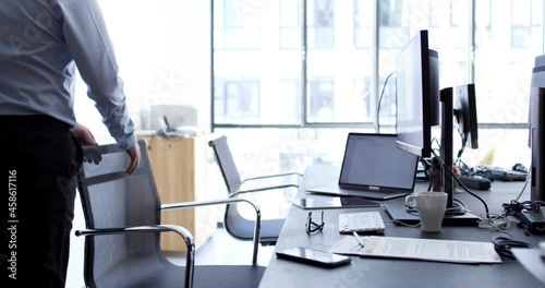 RED camera video of Caucasian male employee dressed in formal wear spending working time in modern office interior with high tech for doing exchange trade, professional in workspace
