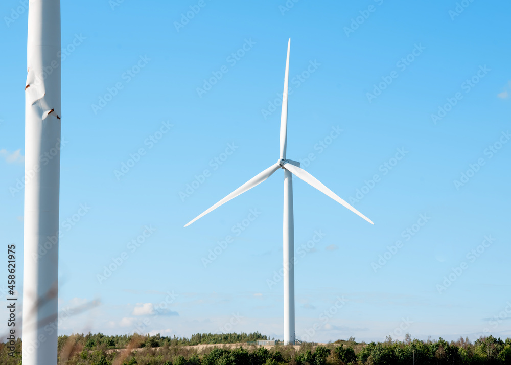 wind turbine in the field against blue sky on sunny day wind turbine in the field against blue sky on sunny day