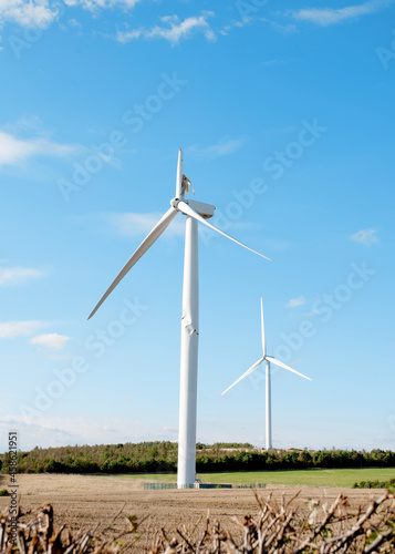 Electricity power wind turbine with broken blade and damaged tower awaiting repair after accident.