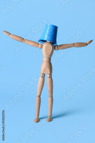 Wooden mannequin in bucket ...