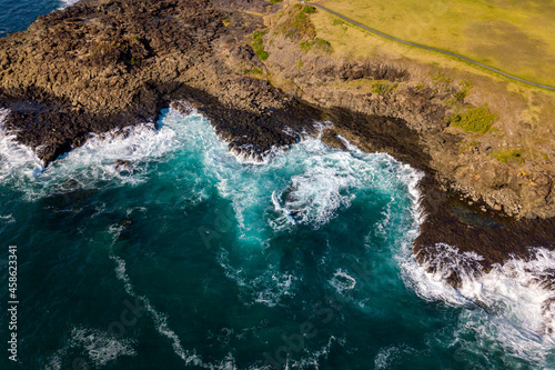 Drone aerial photograph of the ocean crashing against rocks in Kiama