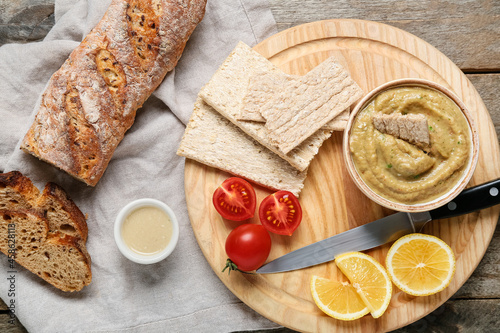 Bowl with tasty baba ghanoush and fresh products on wooden background