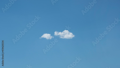 Only two clouds in a blue sky. Great for background