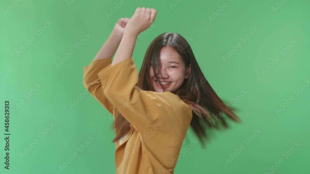The Smiling Asian Woman Dancing Sides While Standing On Green Screen In A Green Screen Studio
The Smiling Asian Woman Dancing Sides While Standing On Green Screen In A Green Screen Studio