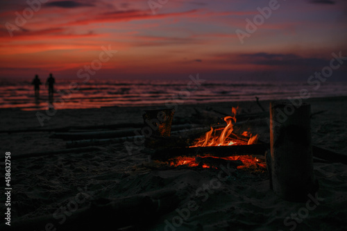 Bonfire by the sea against the background of sunset.