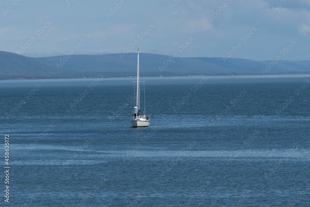 A lone sail boat on the water