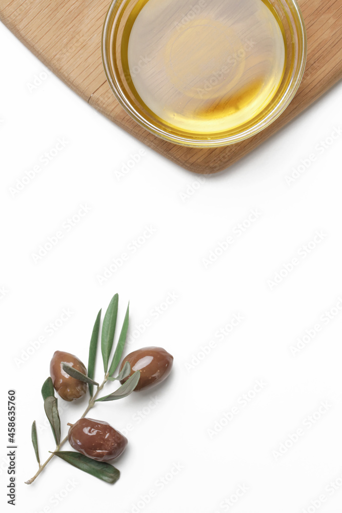 Top view of extra virgin olive oil in bowl and olives isolated on white background.	