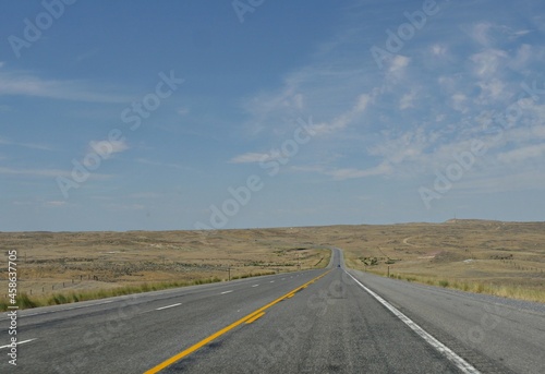 Straight paved road along Wyoming landscape © raksyBH