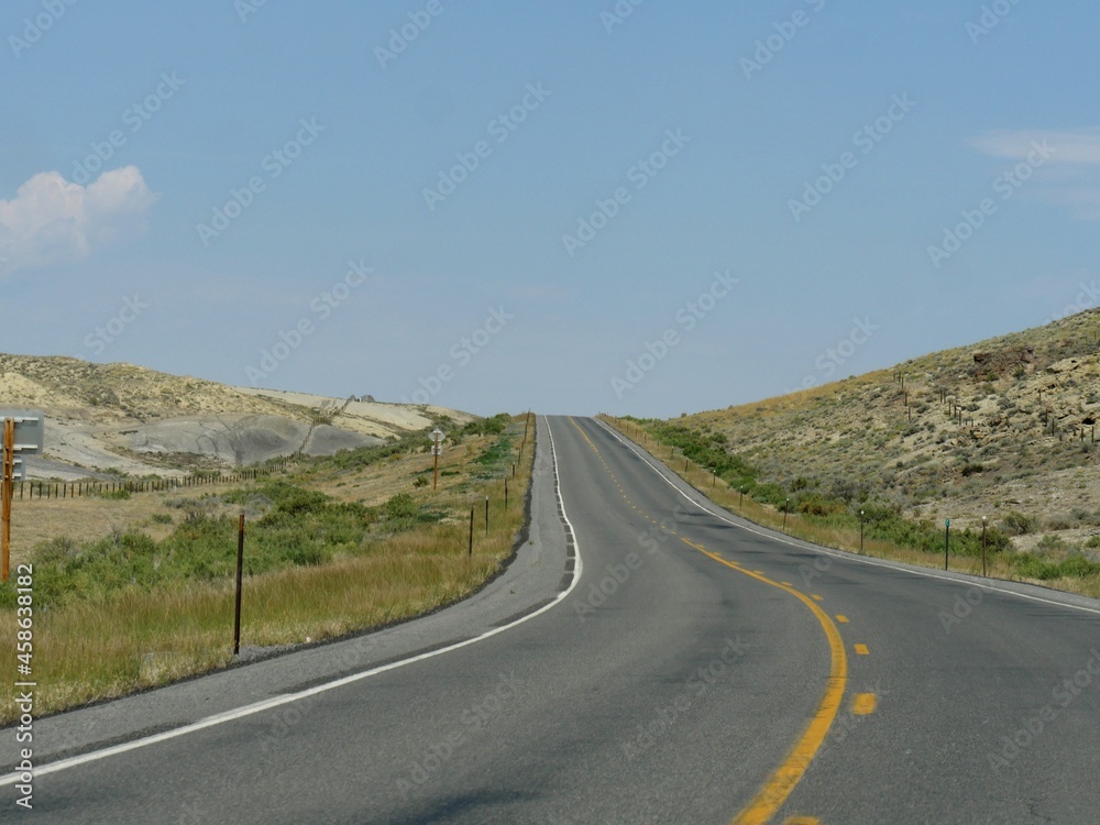 Winding, paved upward road, Wyoming-Montana border landscape