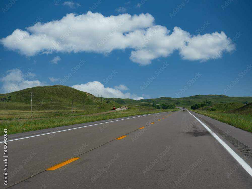 Paved Highway 183 with rolling hills and gorgeous clouds in Nebraska, USA. Paved Highway 183 with rolling hills and gorgeous clouds in Nebraska, USA.